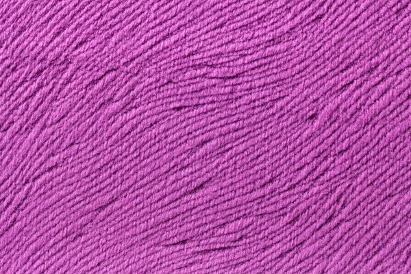 Purple background from soft textile material. Fabric with natural texture.