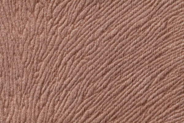 Light brown background from soft textile material. Fabric with natural texture.
