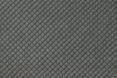 Rhomboid desenli koyu gri kabarık kumaş arka plan, makro. Dekoratif siyah örülmüş tekstil malzemesinden soyut arkaplan.