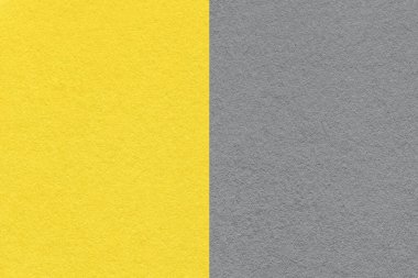 2021 yılının trend rengi. Aydınlatıcı sarı ve nihai gri. Eski, nötr gri kağıt arkaplan dokusu, makro. Geometrik şekilli modern arkaplan.