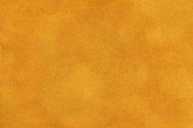 Süet kumaştan koyu turuncu bir arka plan, yakın plan. Kusursuz altın tekstilin kadife dokusu, makro. Ocher 'ın yapısı tuval arkaplanı.