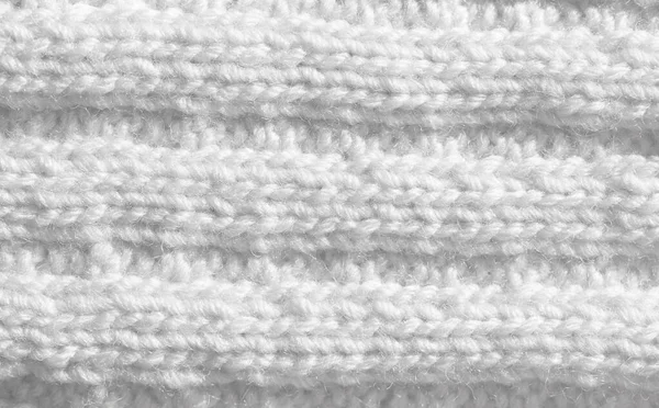 Knitting from woolen threads. Texture for the New Year's postcard. White background for various purposes.