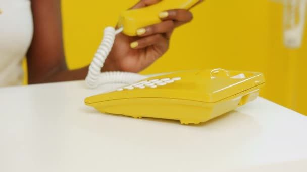 Yellow Telephone In Retro Style is Used by Black Woman — стоковое видео