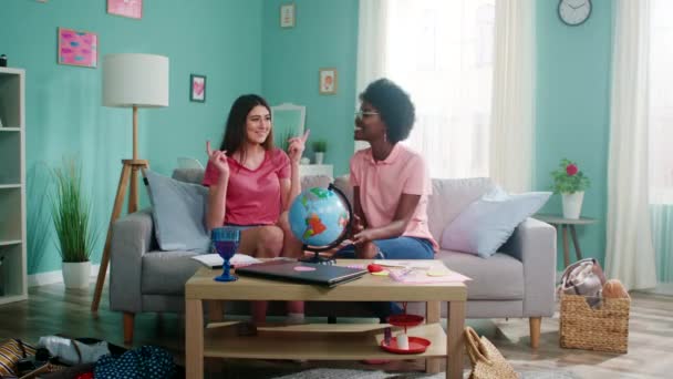 Young Women Use a Globe to Make List of Their Travel Destinations — Stock Video