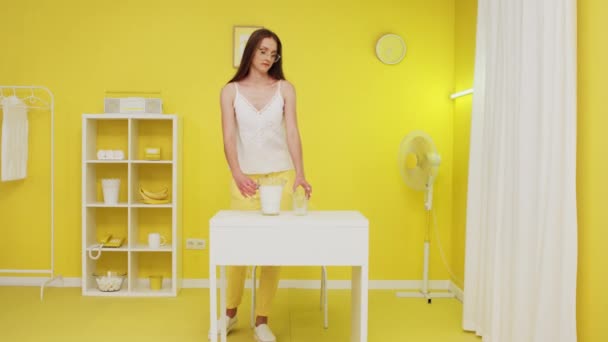 Jeune femme vient dans le tournage et verse du lait dans le verre — Video