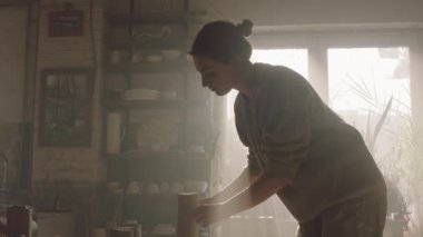 Woman Is Cutting Clay Into Pieces