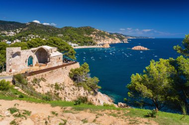 Sunny view of rocky beach from fortress Tossa de Mar, Girona province, Spain. clipart