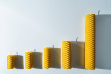 Balmumundan yapılmış dekoratif mumlar. İçi bal aromalı ve beyaz arka planda gelenek..