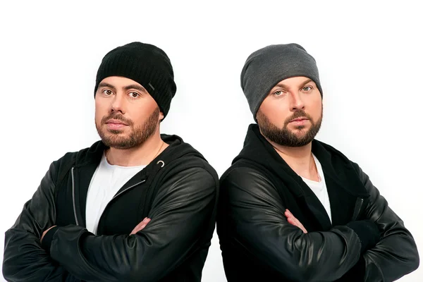 Portrait of two men in black jackets and hats — Stock Photo, Image