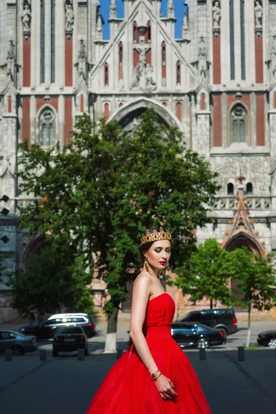 Bella ragazza in abito rosso lungo e in reale — Foto Stock