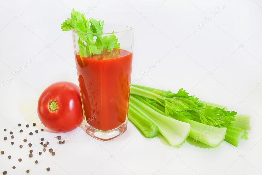 Glass of tomato juice with selery, pepper, carrot and tomatoes