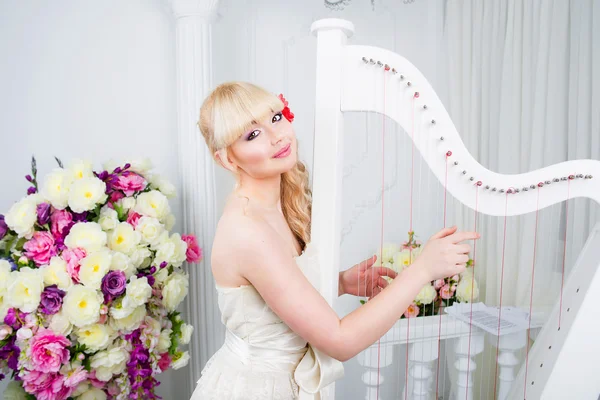 Mulher de vestido longo tocando harpa — Fotografia de Stock