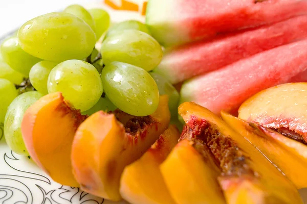 Peach, white grape, watermelon and melon on the plate — Stock Photo, Image