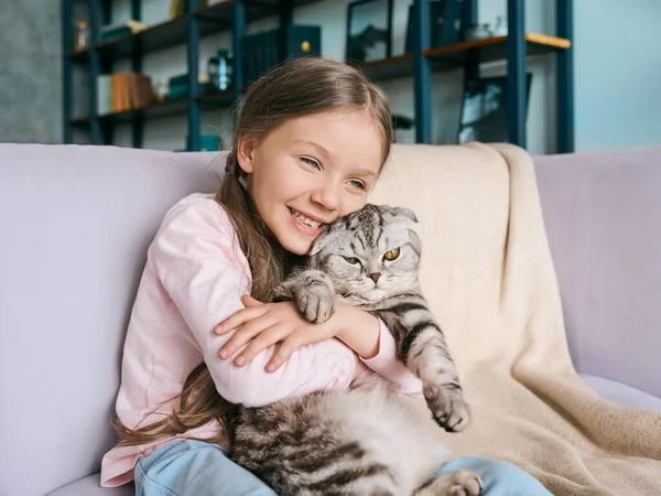 Bedårande Söt Leende Flicka Kramar Skotsk Grå Katt Soffan Hemma — Stockfoto