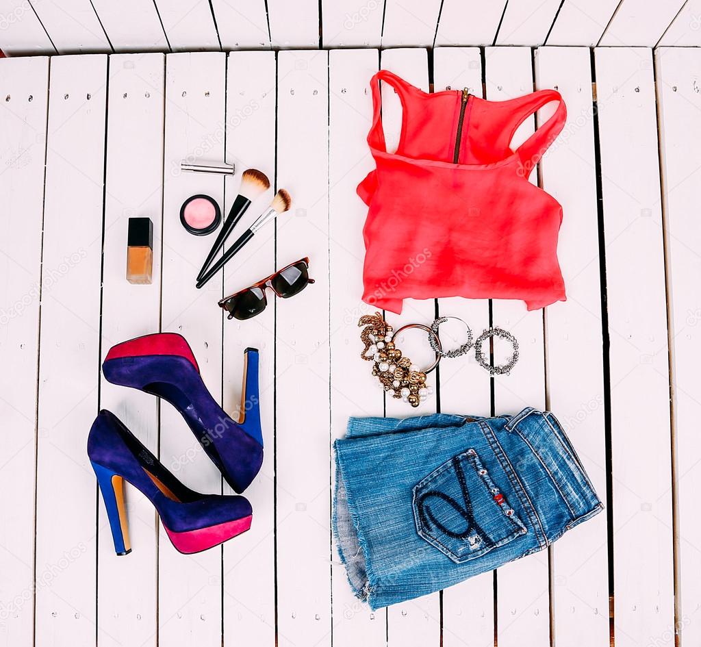 Stylish collage of clothes on wooden background bright summer topom jewelry cosmetics and super trendy top , ornaments and bright shoes