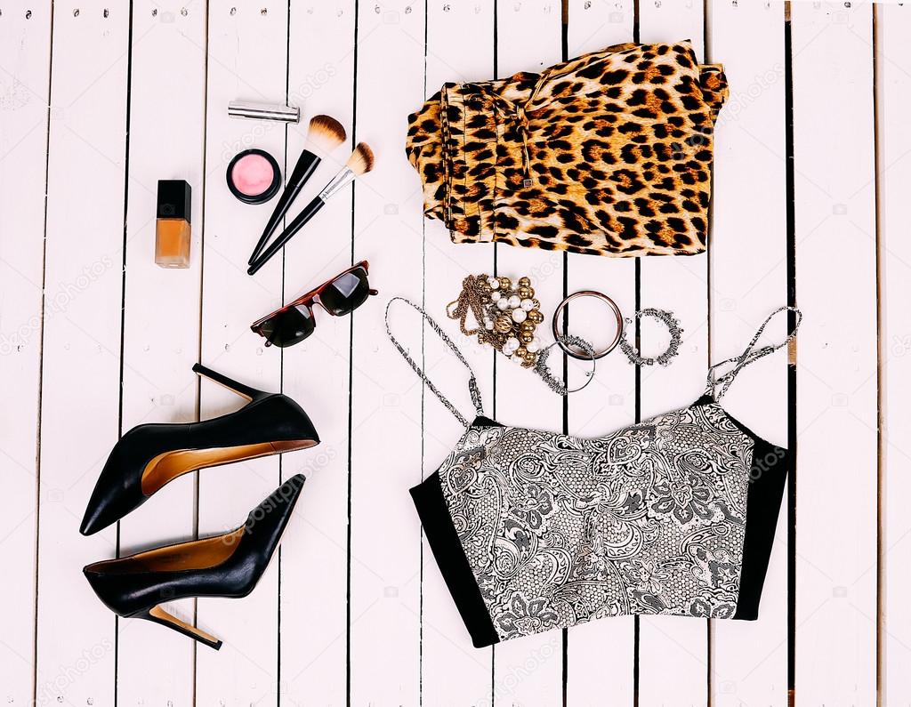 stylish collage of clothes on the wooden background with bright summer topom ornaments cosmetics and fashion leopard pants tuflyamii