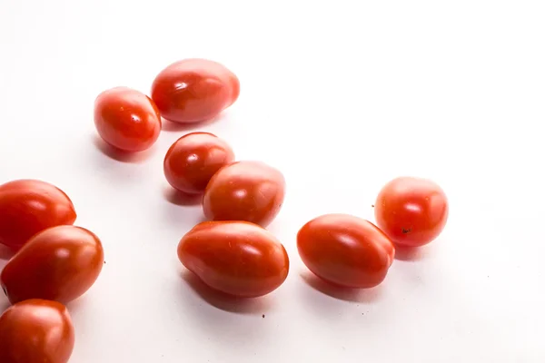 Some tomatoes on a white background — Stock Photo, Image