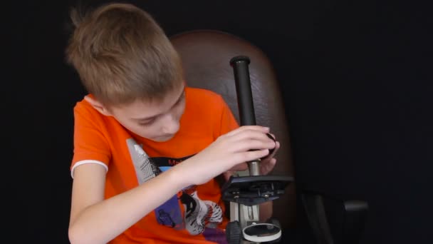 Щаслива дитина дивиться мікроскоп — стокове відео