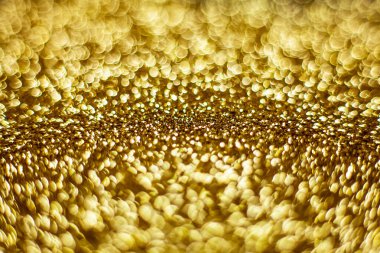 Altın tozu arka planda bulanıklık, küçük altın tozu ışığı yansıtır