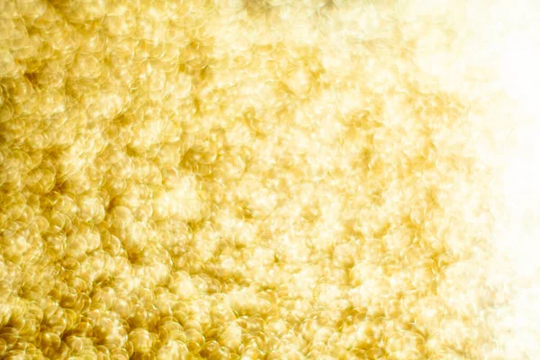 Gold dust background blurred, small gold dust reflects light