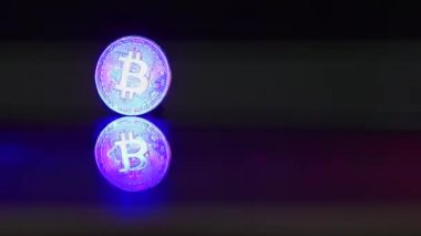 bitcoin gold coin stands on a table a thief puts his hand on. Bitcoin extraction concept. Popular cryptocurrency