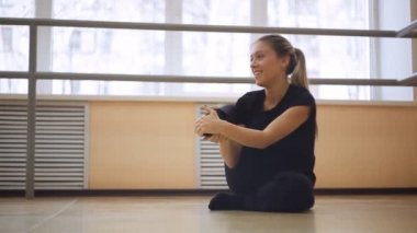 genç kız dans salonunda egzersiz yapıyor. yere