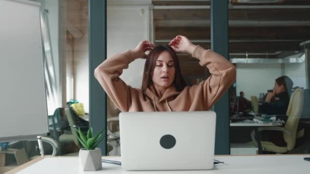 Attractive healthy calm millennial woman in beige hoodie relaxing on comfortable chair napping feel stress free at office break alone — Stock Video