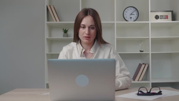 Mujer caucásica joven confusa leyendo correo electrónico en la computadora, sintiéndose deprimido de obtener malas noticias en línea, fracaso del examen profesional, recibir aviso de despido, concepto de trabajo perdido. — Vídeo de stock