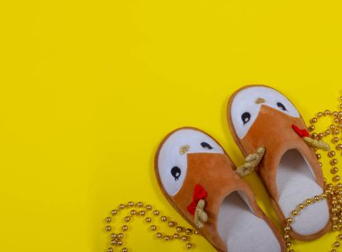 Saf altın boncuklar ve ev terlikleri sarı arka planda Noel geyiği şeklinde. Noel ve Yeni Yıl konsepti. Evde kal. Kartpostal Uzayı kopyala Düz yatıyordu