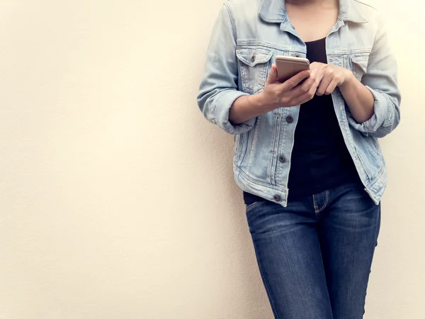 stock image Woman in jeans fashion using mobile phone