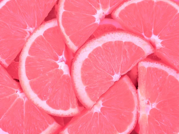 Fatias de laranja como textura de fundo em rosa — Fotografia de Stock