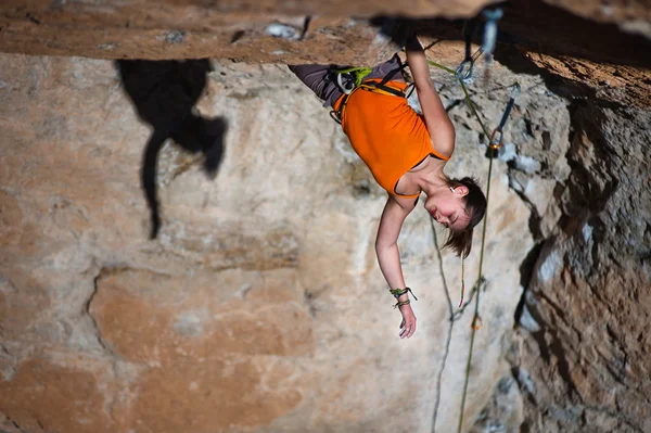 Girl climber climbs on rock. — Stock Photo, Image