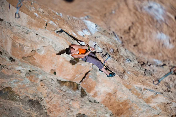 Girl climber climbs on rock. — Stock Photo, Image