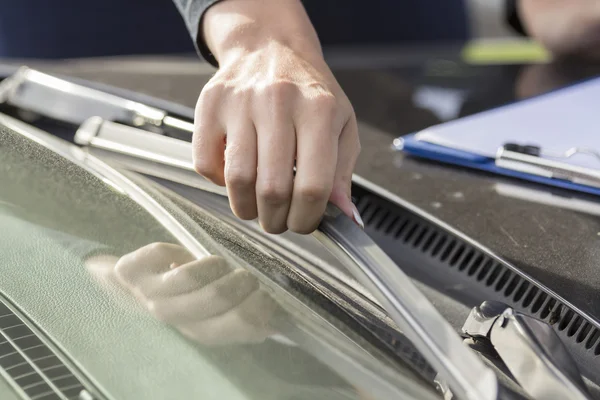 stock image Girls hand checks wipers car.