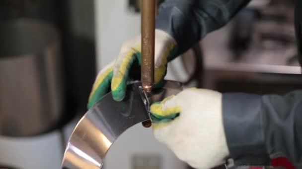 Un soudeur à gants travaille sur une machine à souder par points. Soudage de cheminée. Un opérateur travaille avec le soudage par points pour souder une tôle d'acier inoxydable dans une usine d'une industrie. — Video