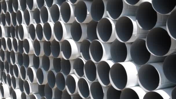 Downpipe warehouse. Steel pipes, parts for the construction of a roof drainage system in a warehouse. Stack of stainless steel pipes. — Stock Video