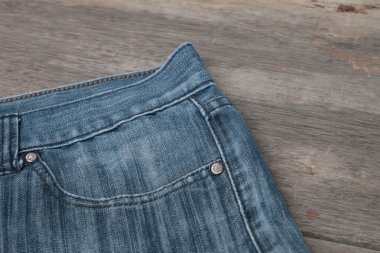 Mavi jeans kahverengi ahşap arka plan üzerinde
