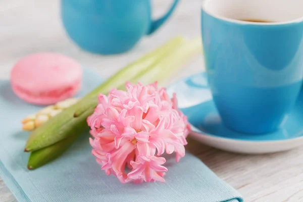 Tasse schwarzen Kaffee und rosa Blume — Stockfoto