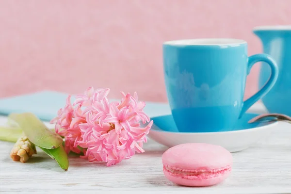 Tasse schwarzen Kaffee, rosa Blumen und französische Makronen — Stockfoto