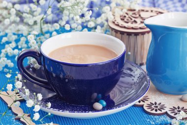 Beyaz ahşap bir masa üzerinde sütlü kahve