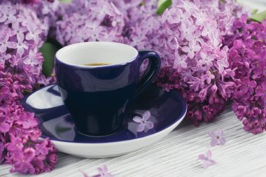 Fincan sade kahve, Eflatun çiçekler ve tatlı pastel Fransız macar