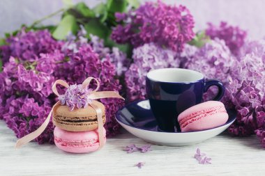 Fincan sade kahve, Eflatun çiçekler ve tatlı pastel Fransız macar