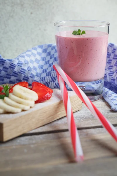 Delicious strawberry and banana smoothie or milk shake with fres