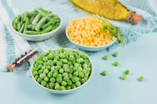 Green peas, sweet corn and cut green beans in a bowl. Concept of homemade preparations for fast cooking. Healthy vegetarian food concept