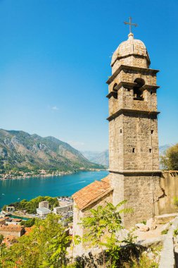 View on Church, ancient walls, mountains and sea in Kotor old town. Montenegro, Kotor bay