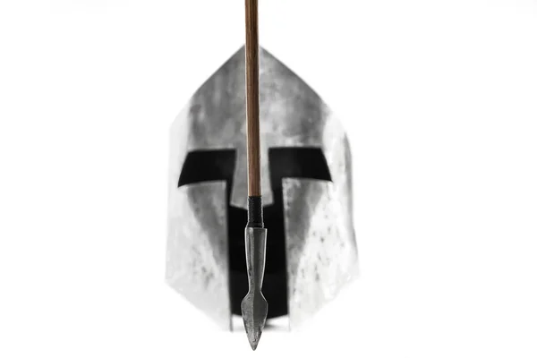 Ancient iron spartan helmet and arrow isolated on white. — Stock Photo, Image
