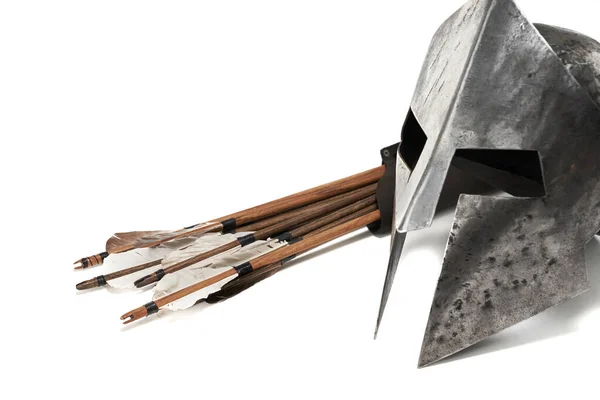 Ancient helmet and wooden arrows isolated on white. — Stock Photo, Image