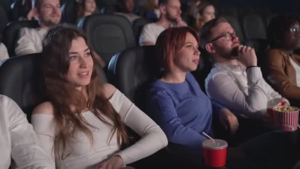 Parejas jóvenes viendo comedia en el cine. — Vídeos de Stock