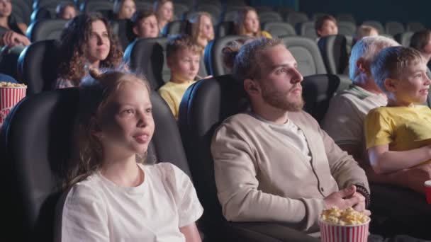 Young man with younger sister in cinema. — Stock Video