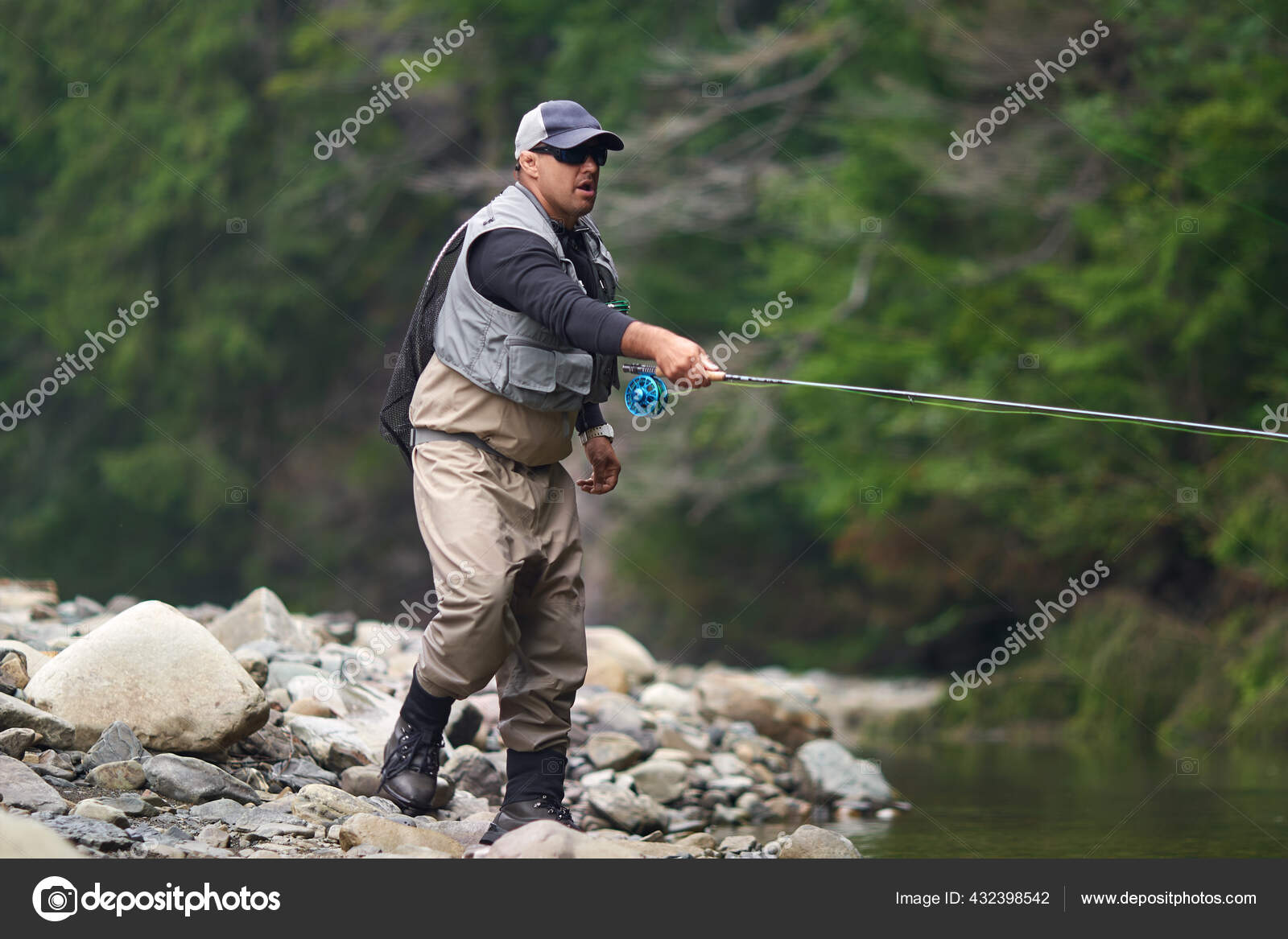 Fishermen in waterproof outfit fishing with rod — Stock Photo